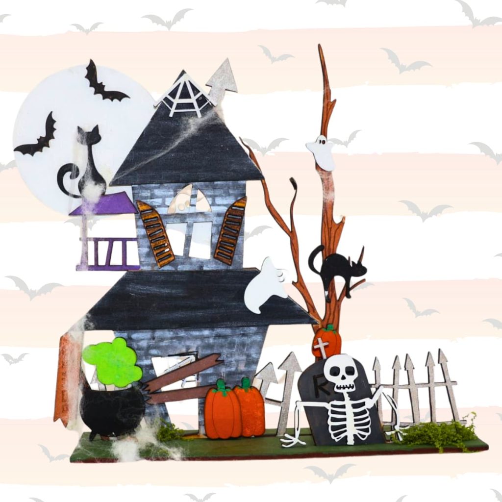 A spooky Hallowe’en scene with a crooked haunted house, ghosts, bats, black cats, a bubbling cauldron, pumpkins, a skeleton, a tombstone, and a fence against a pale bat-patterned background.